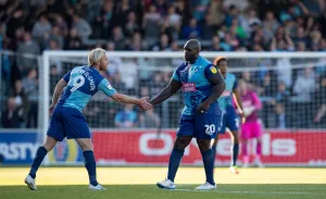 Sufc Prints: A Battle of Strength: Mackail-Smith and Akinfenwa's Showdown against Southend United